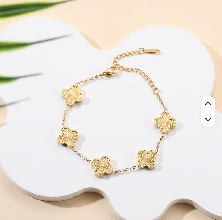 Gold plated bracelets on model hand. 
